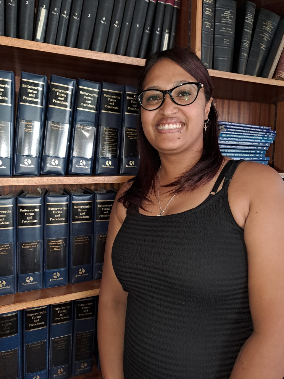 Conveyancing assistant in front of book shelf